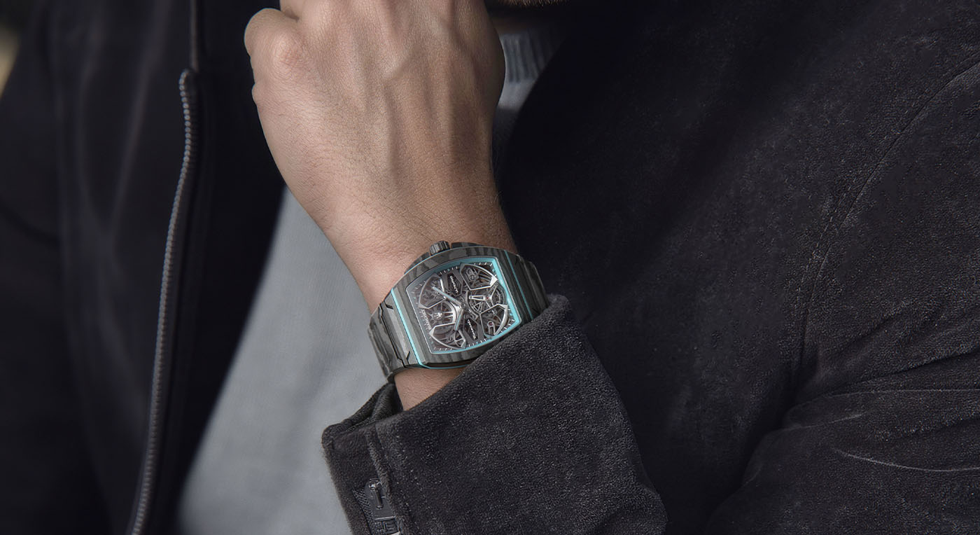A person wearing a sleek, UltraFino Maserati Flying Tourbillon metallic watch with intricate gears on the dial, dressed in a dark leather jacket. The scene conveys elegance and sophistication.